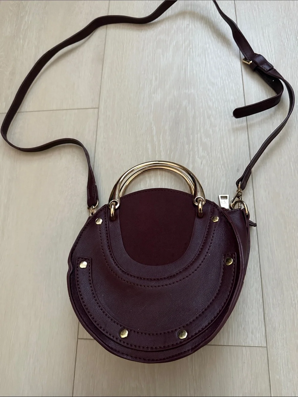 Round Crossbody Bag in Plum with Gold Accents